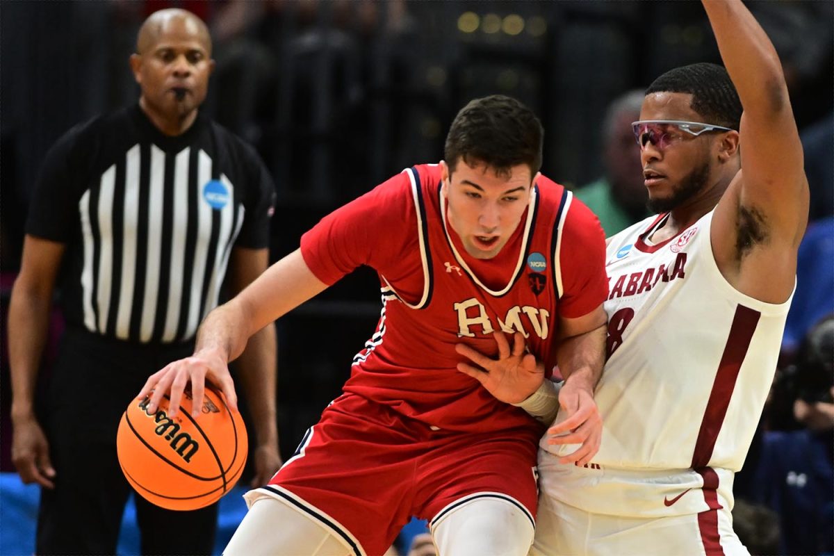 Mar 21, 2025; Cleveland, OH, USA; Robert Morris Colonials forward Alvaro Folgueiras (7) plays the ball defense day Alabama Crimson Tide guard Chris Youngblood (8) in the second half during the NCAA Tournament First Round at Rocket Arena. 